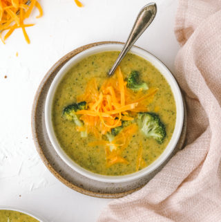 spoon in a bowl of broccoli cheddar soup