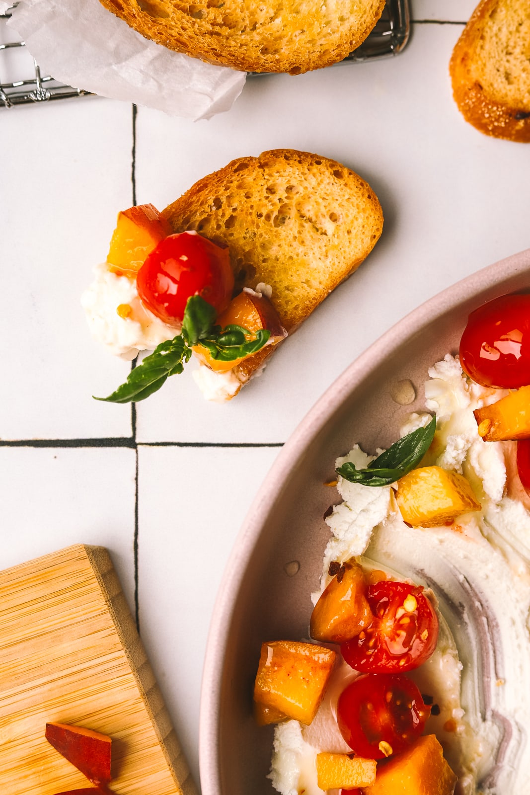 goat cheese, tomatoes and peaches on a crostini