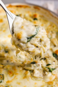 side angle spoonful of spinach artichoke orzo