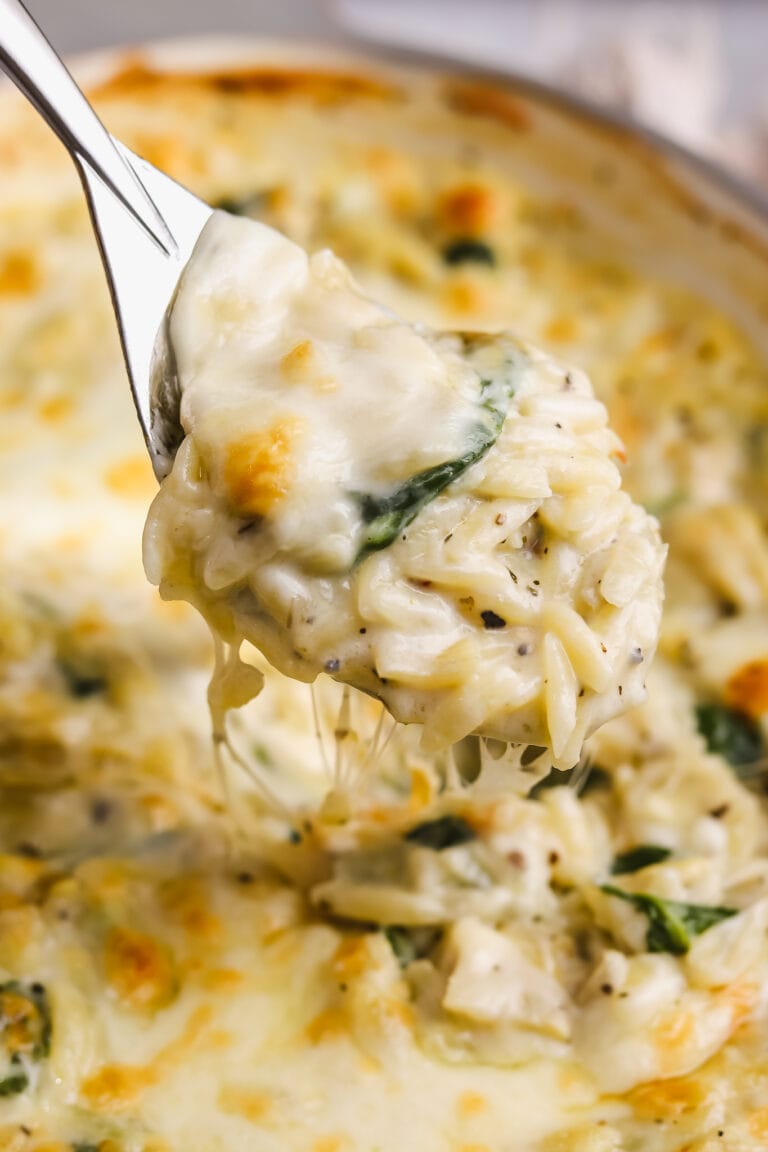 side angle spoonful of spinach artichoke orzo