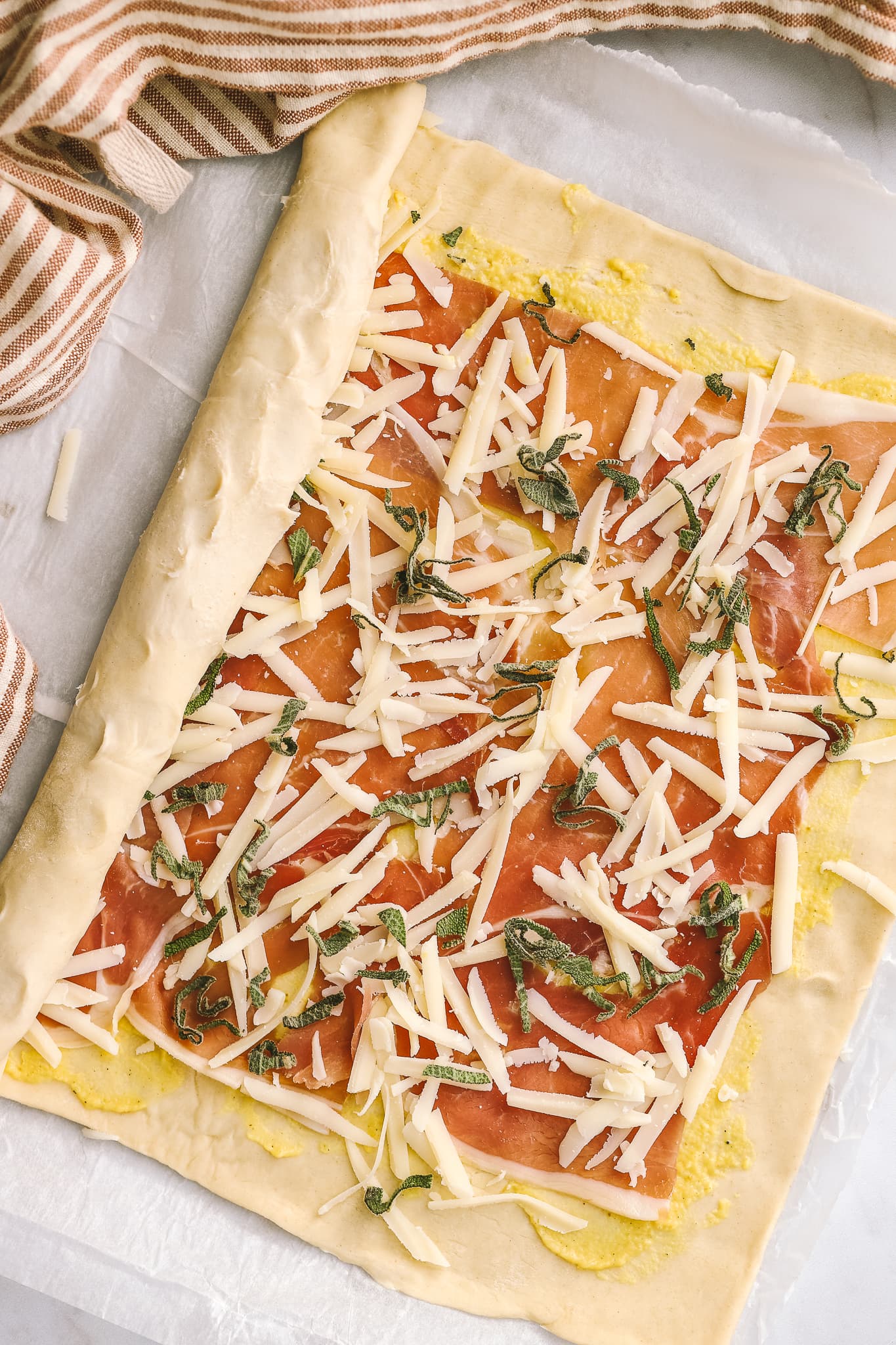 flatlay of puff pastry pinwheels getting rolled