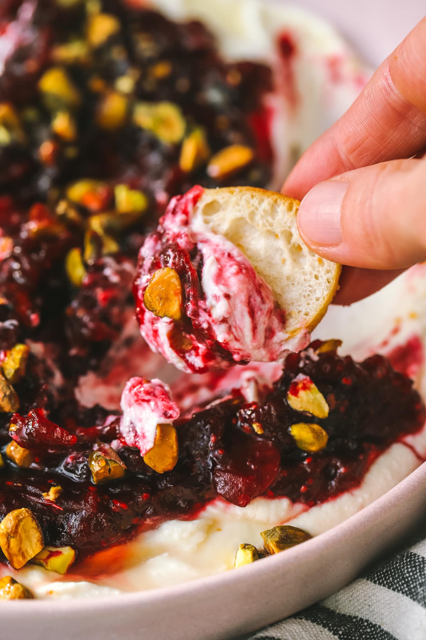 crostini dipped into cranberry feta appetizer
