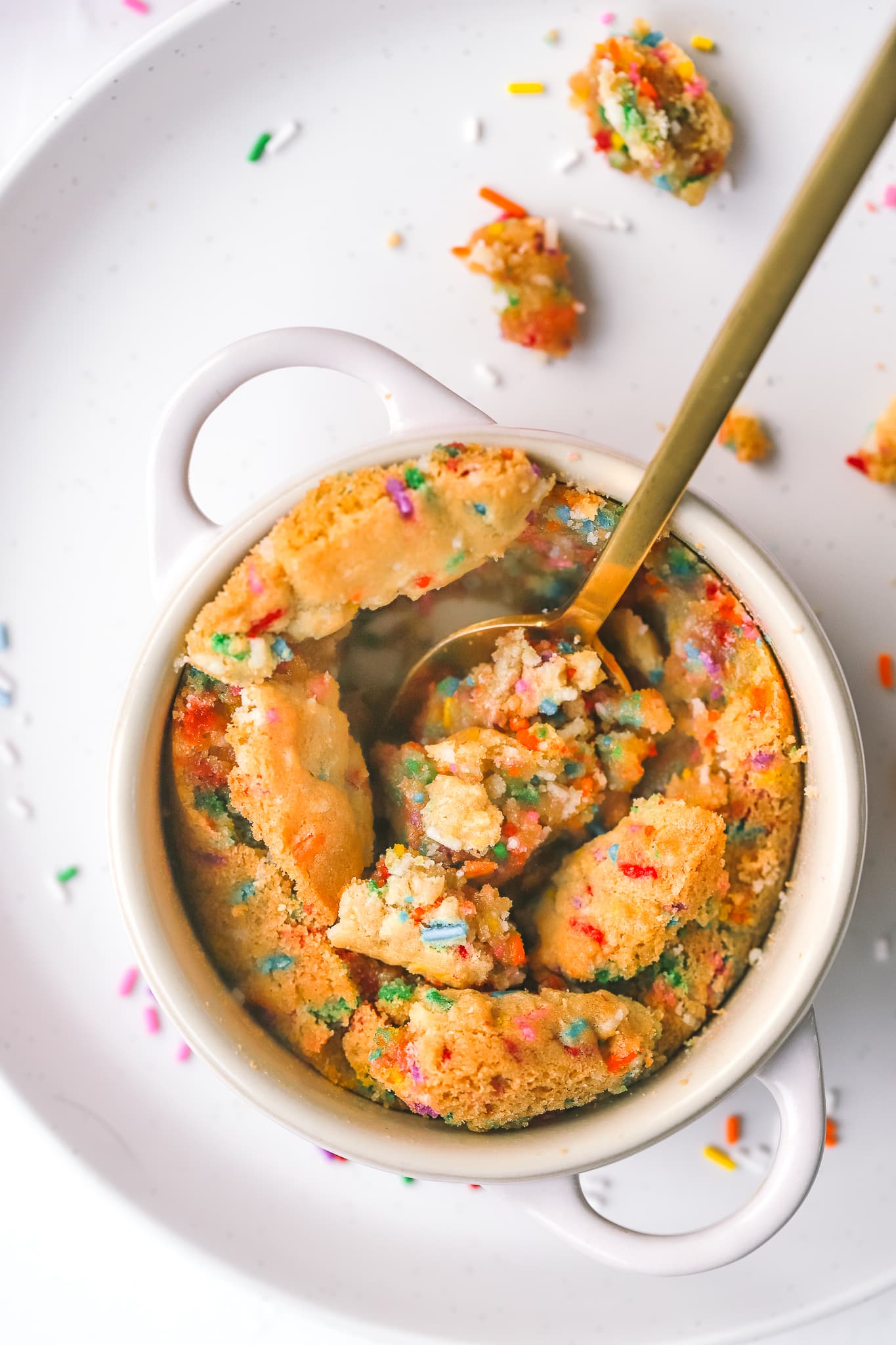 spoon digging into ramekin of sugar cookie