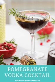 pomegranate cocktail in a coupe glass garnished with rosemary sprig