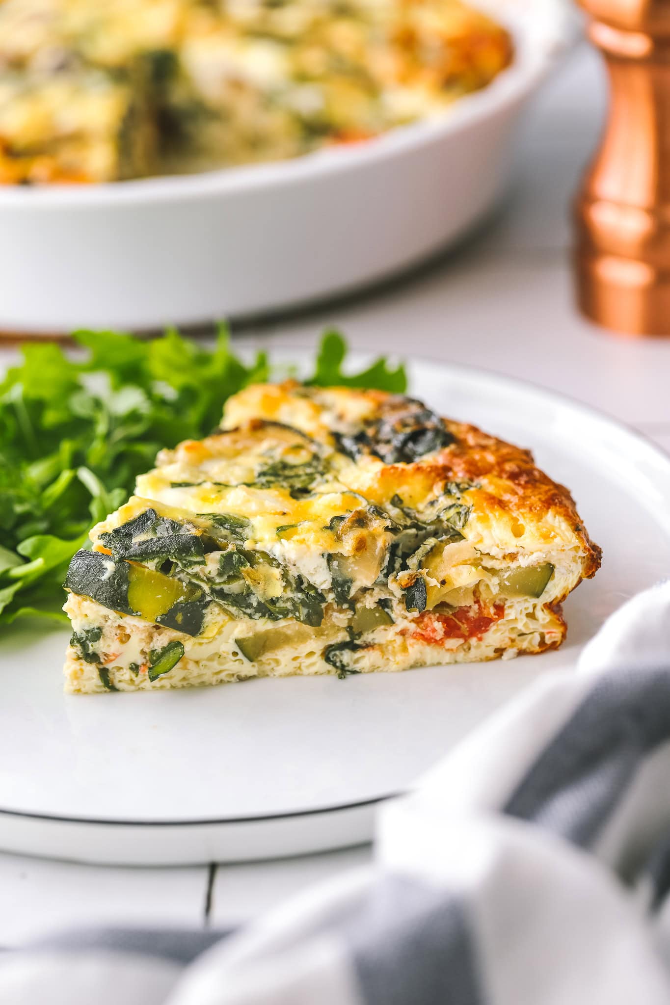 side angle of a slice of veggie quiche
