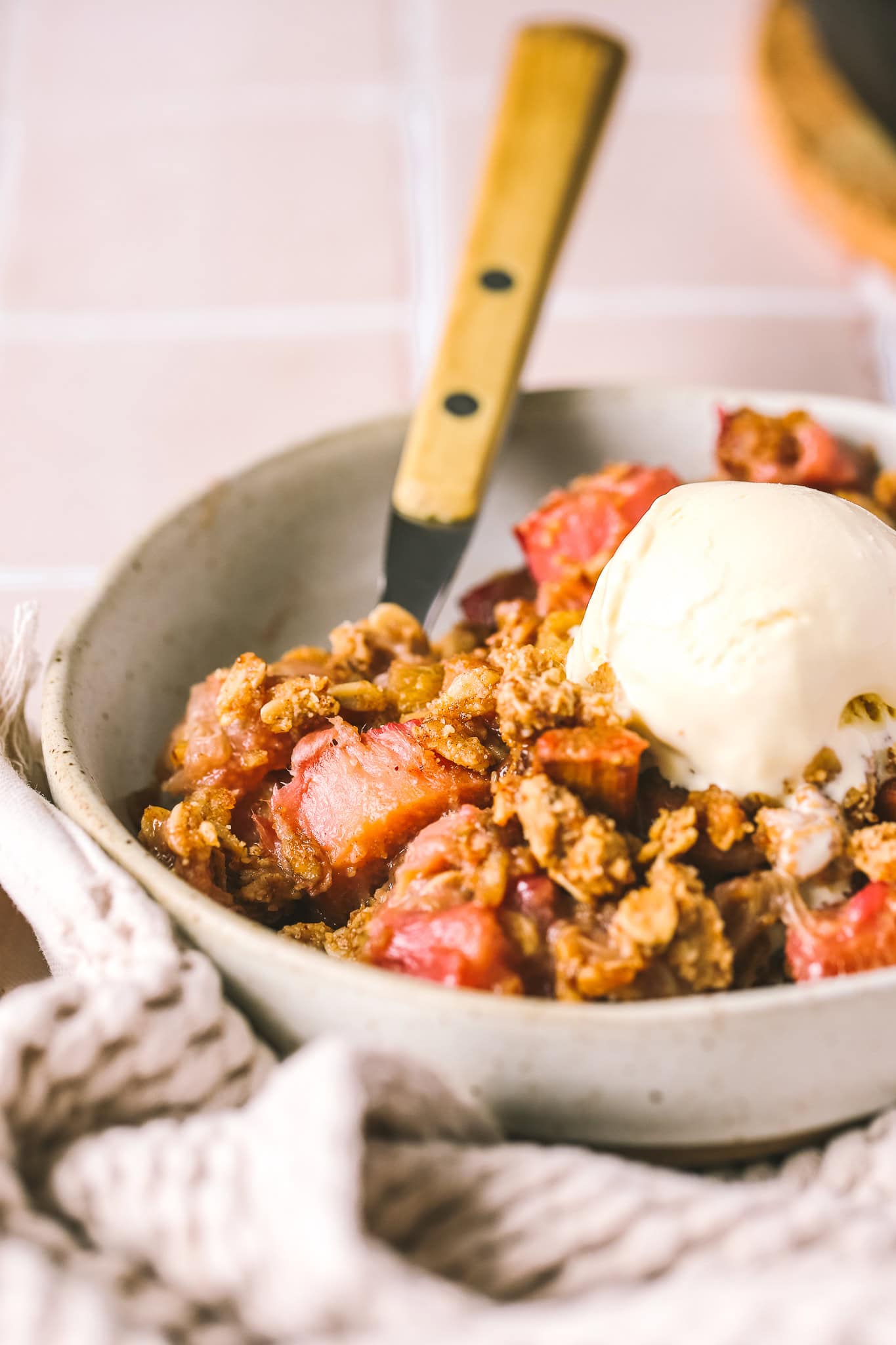side angle gluten free crisp in a bowl with ice cream