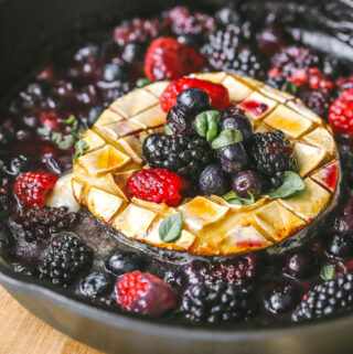 side angle brie in a pan topped with berries