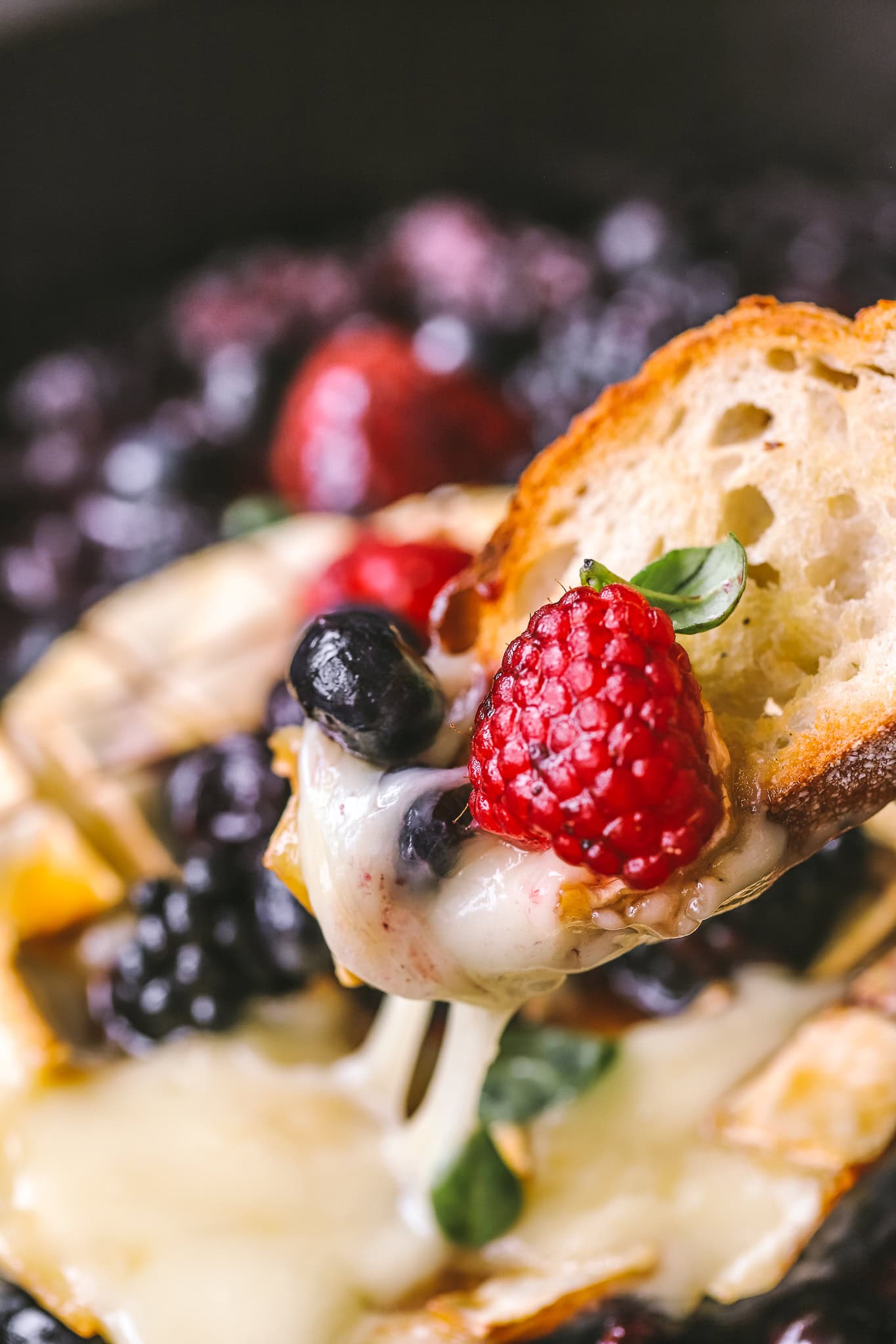 baguette dipped into creamy brie