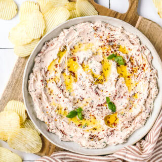 sundried tomato dip in a serving bowl with chips