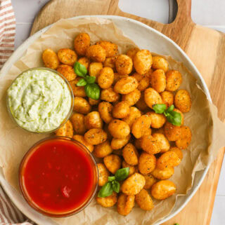 air fryer gnocchi on a plate with two dipping sauces