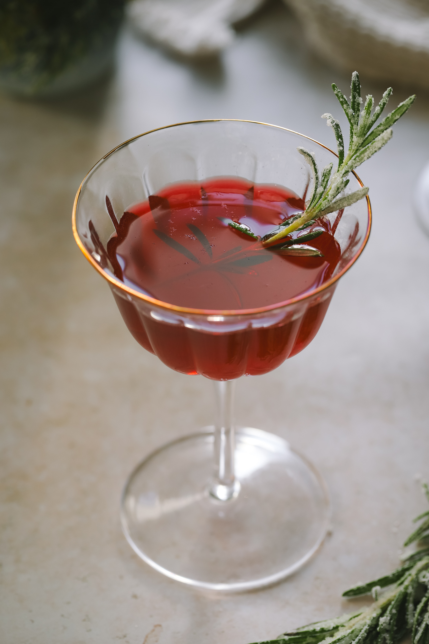angled shot Christmas cosmopolitan in a coupe glass