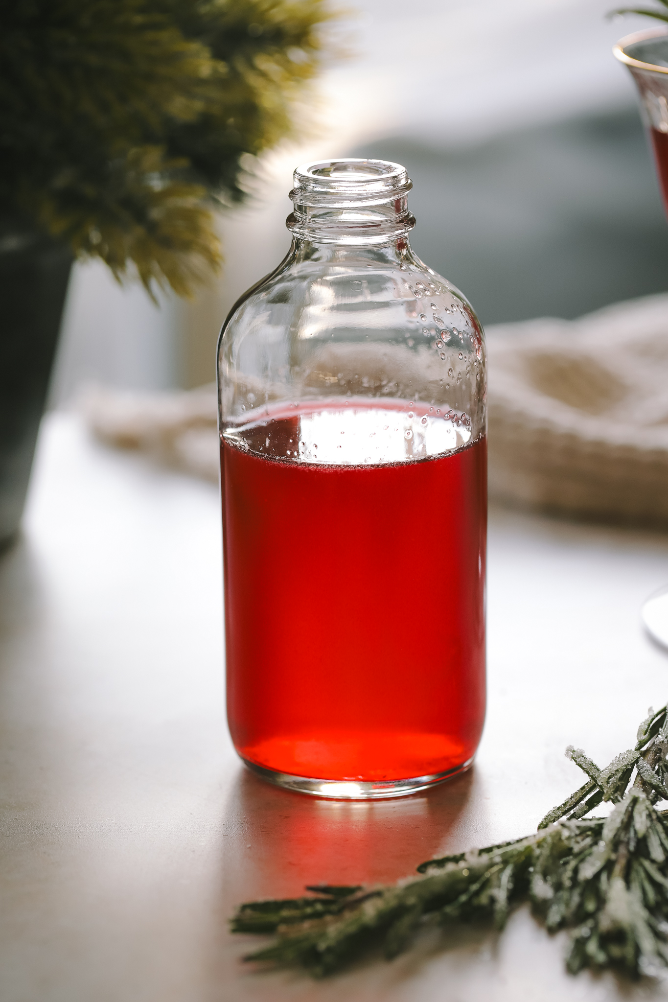 cranberry rosemary simple syrup in a jar