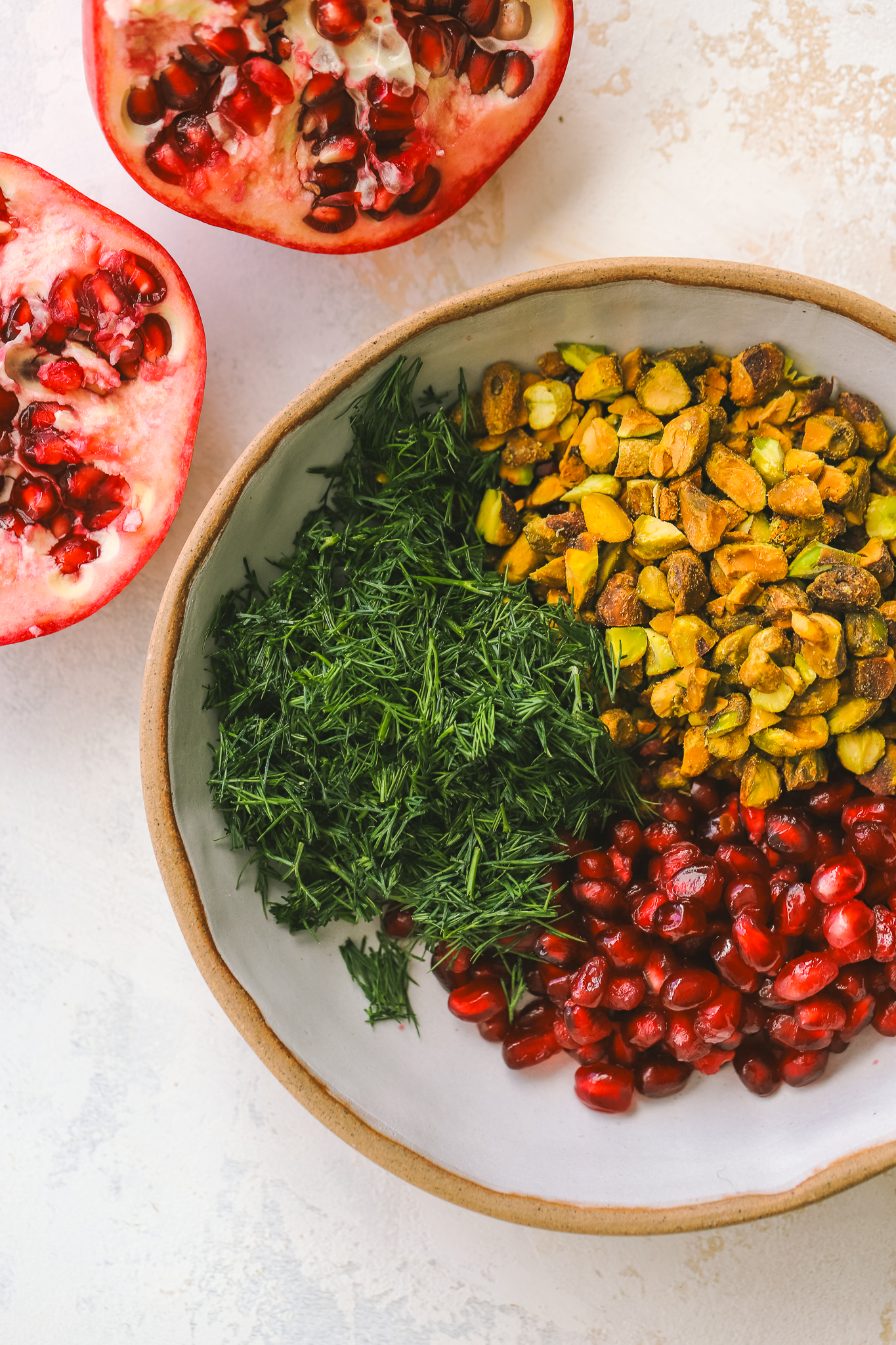 pistachios, fresh dill and pomegranate seeds in a bowl