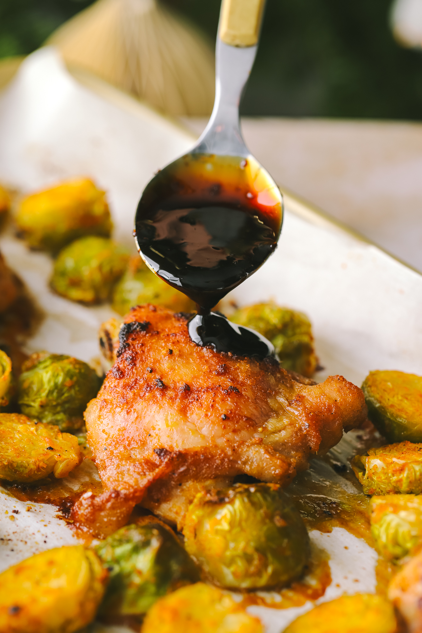 pomegranate sauce being drizzled on chicken