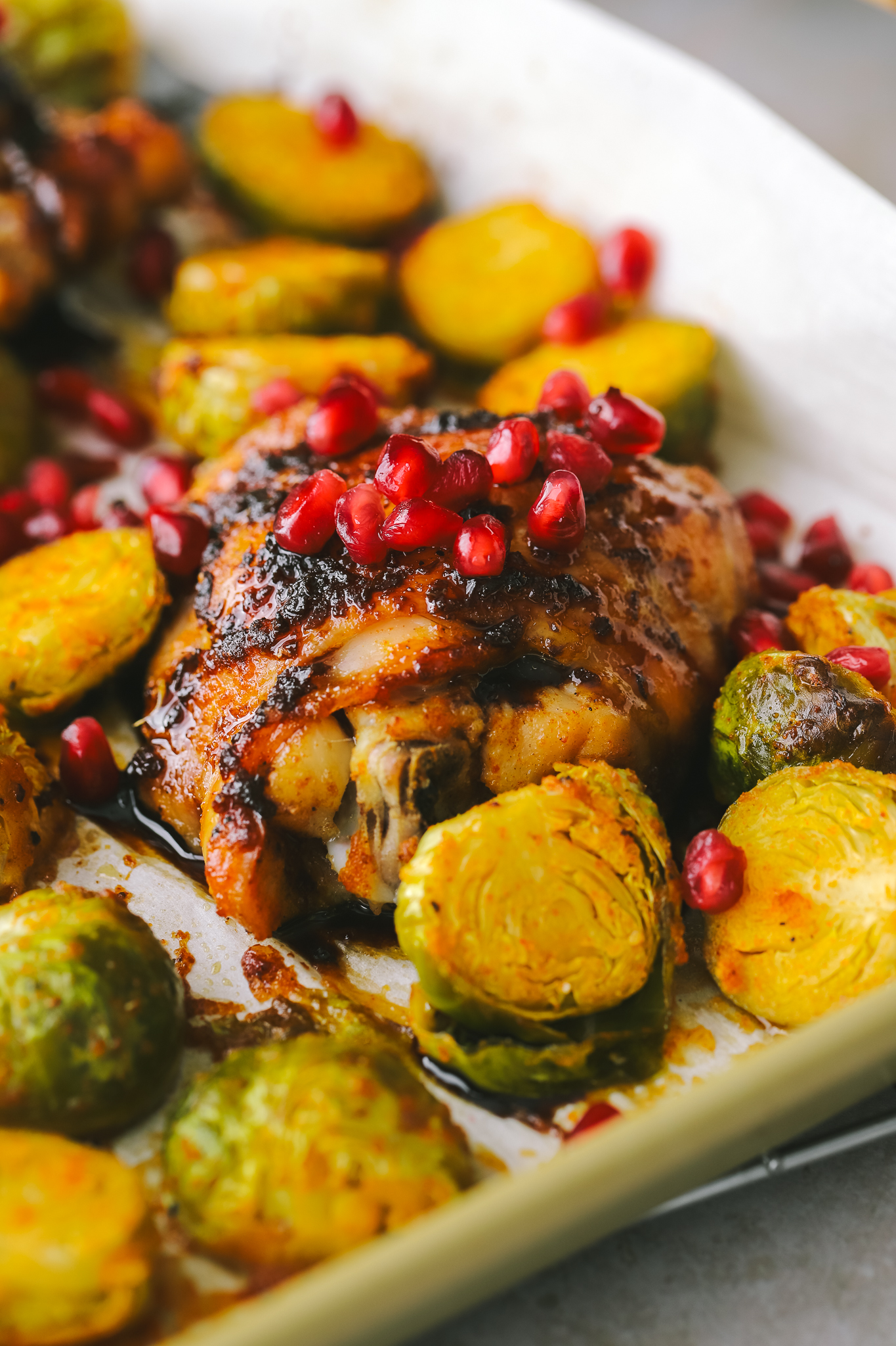 close up of chicken thighs with pomegranate seeds