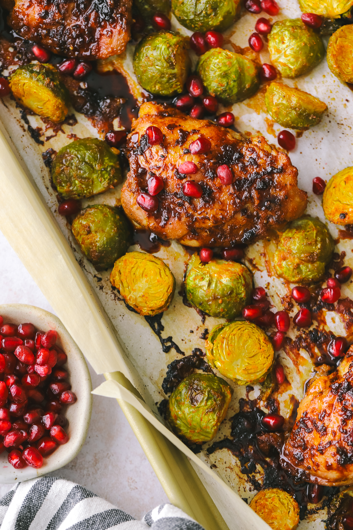pomegranate chicken dinner on a sheet pan