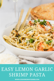shrimp pasta in a bowl with fork and spoon
