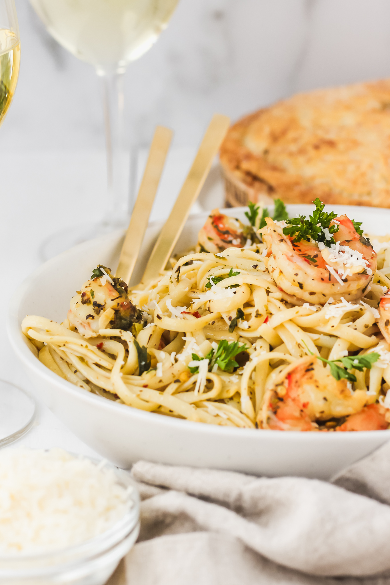 shrimp pasta in a bowl with fork and spoon