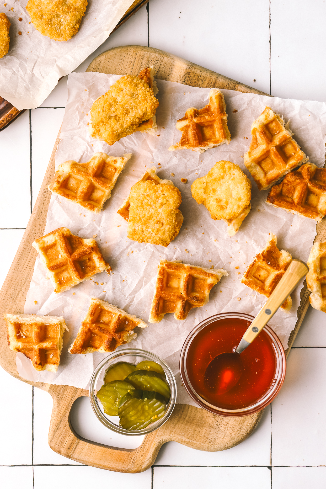 pieces of chicken and waffles on a serving board