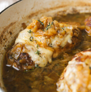 close up of chicken with caramelized onions and melted gruyere cheese