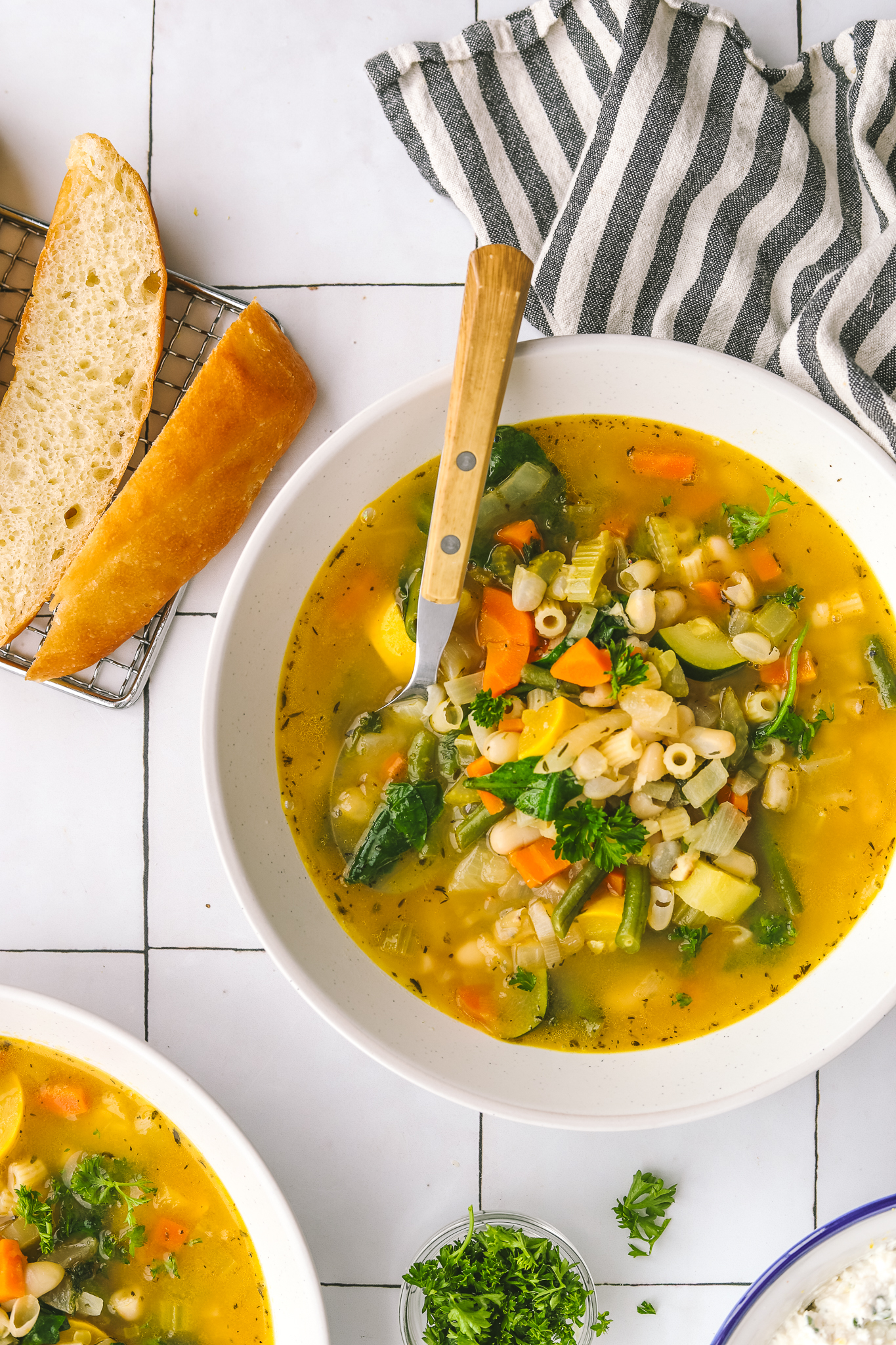 Spring minestrone soup served with bread