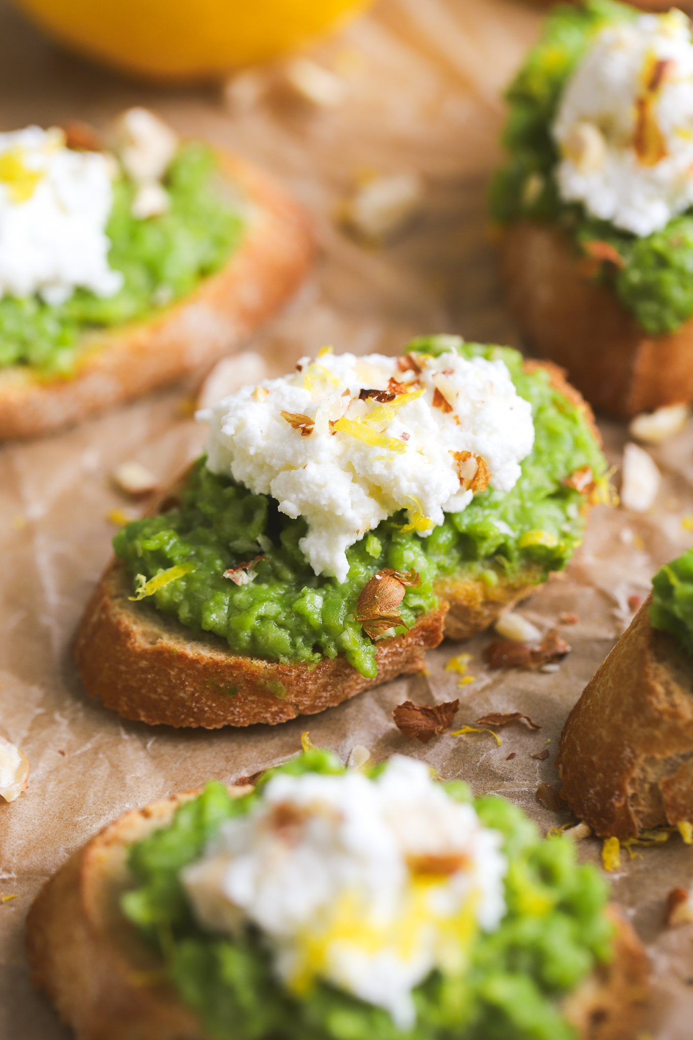 crostini with smashed green peas, ricotta and hazelnuts