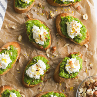 crostini with smashed Spring peas, dollop of ricotta cheese, lemon zest and hazelnuts