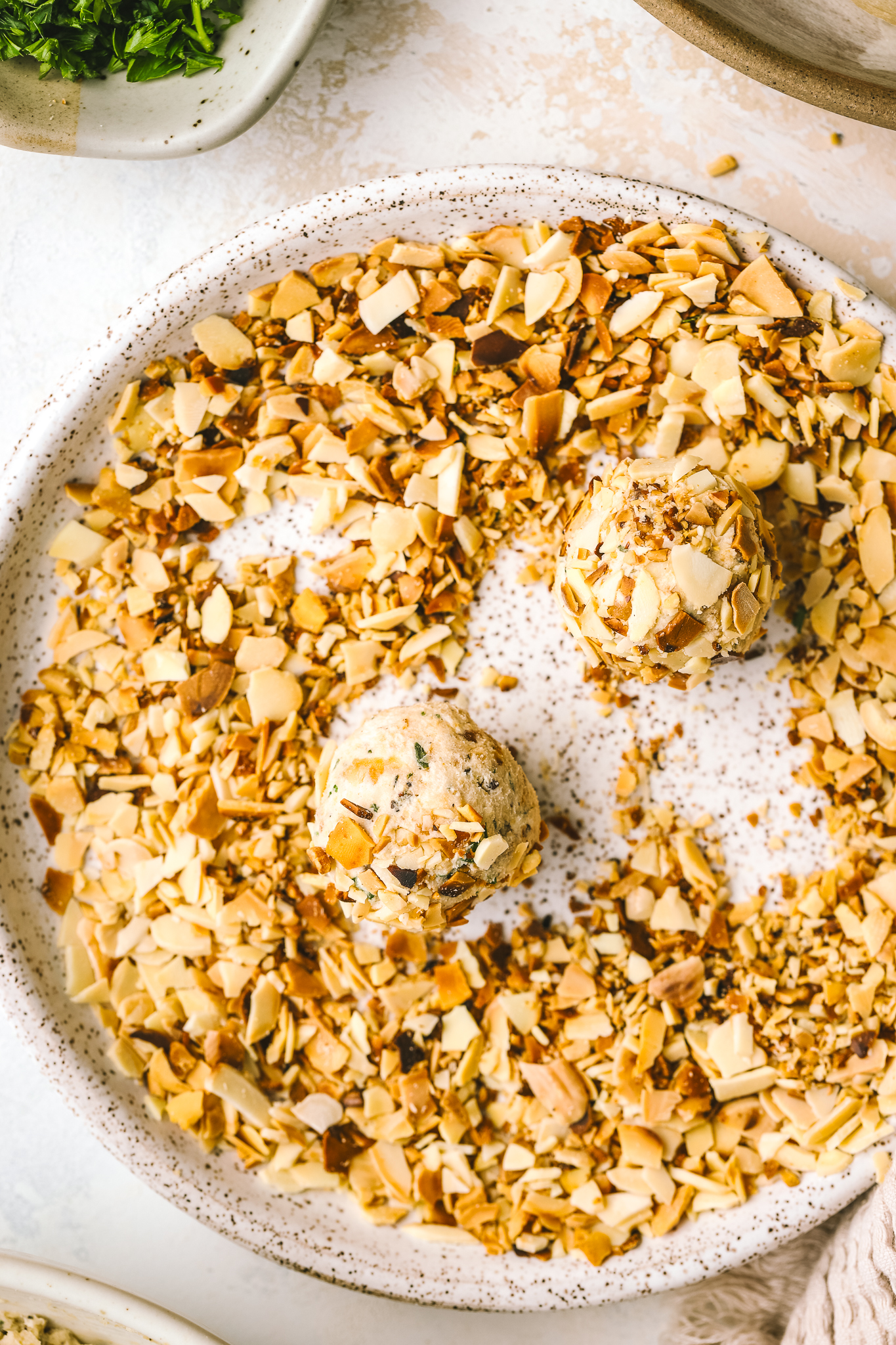 close up mini cheese balls rolled in almonds