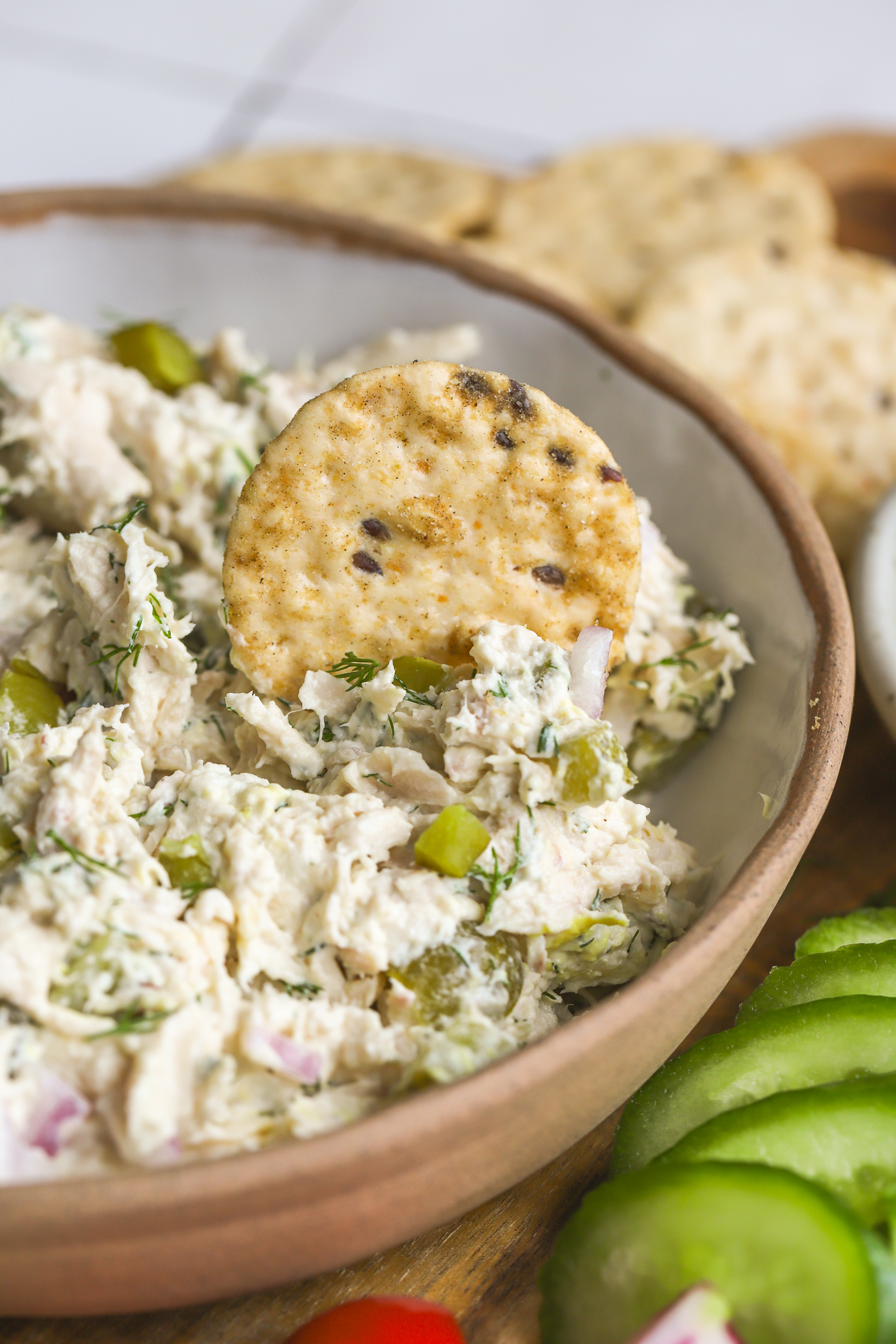 cracker dipping into chicken salad