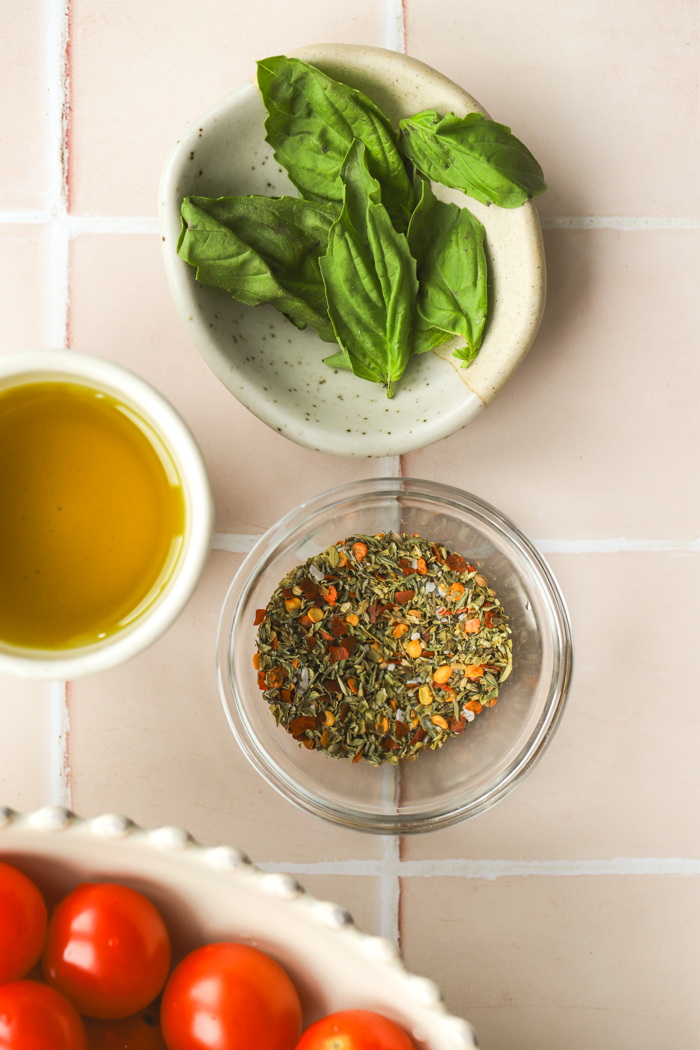 olive oil, spices and basil in bowls