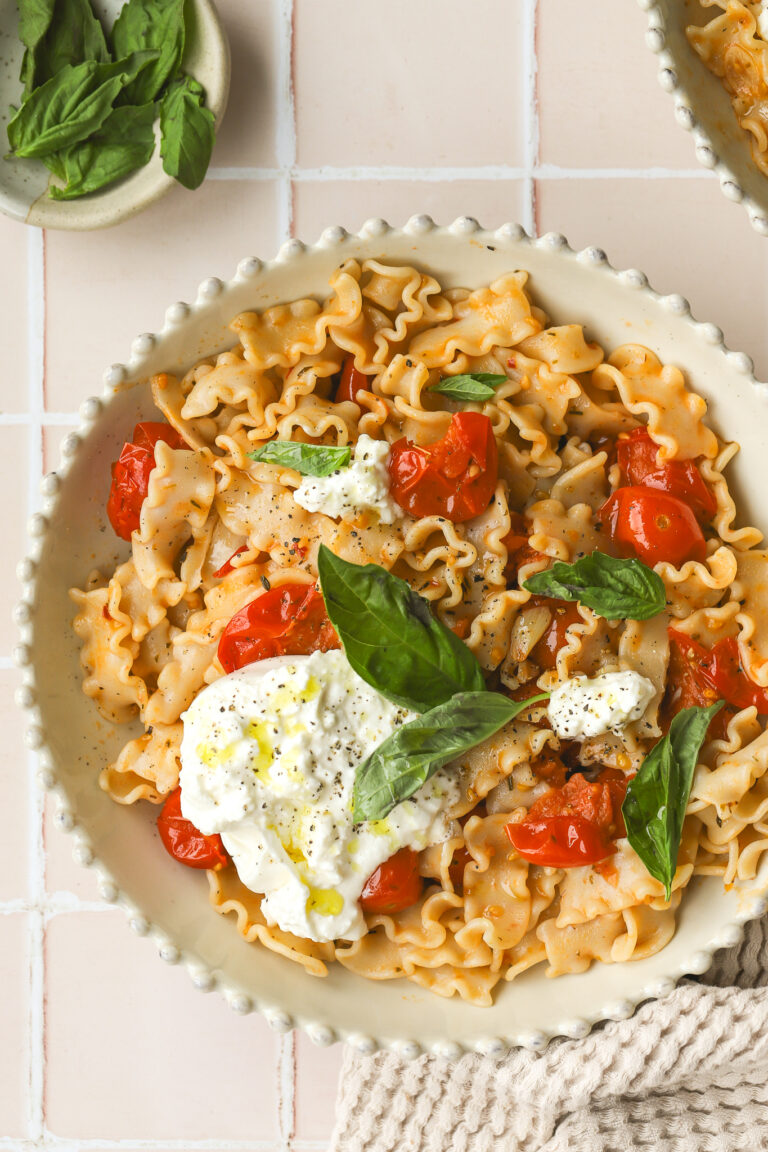 overhead of burst cherry tomato pasta in a bowl