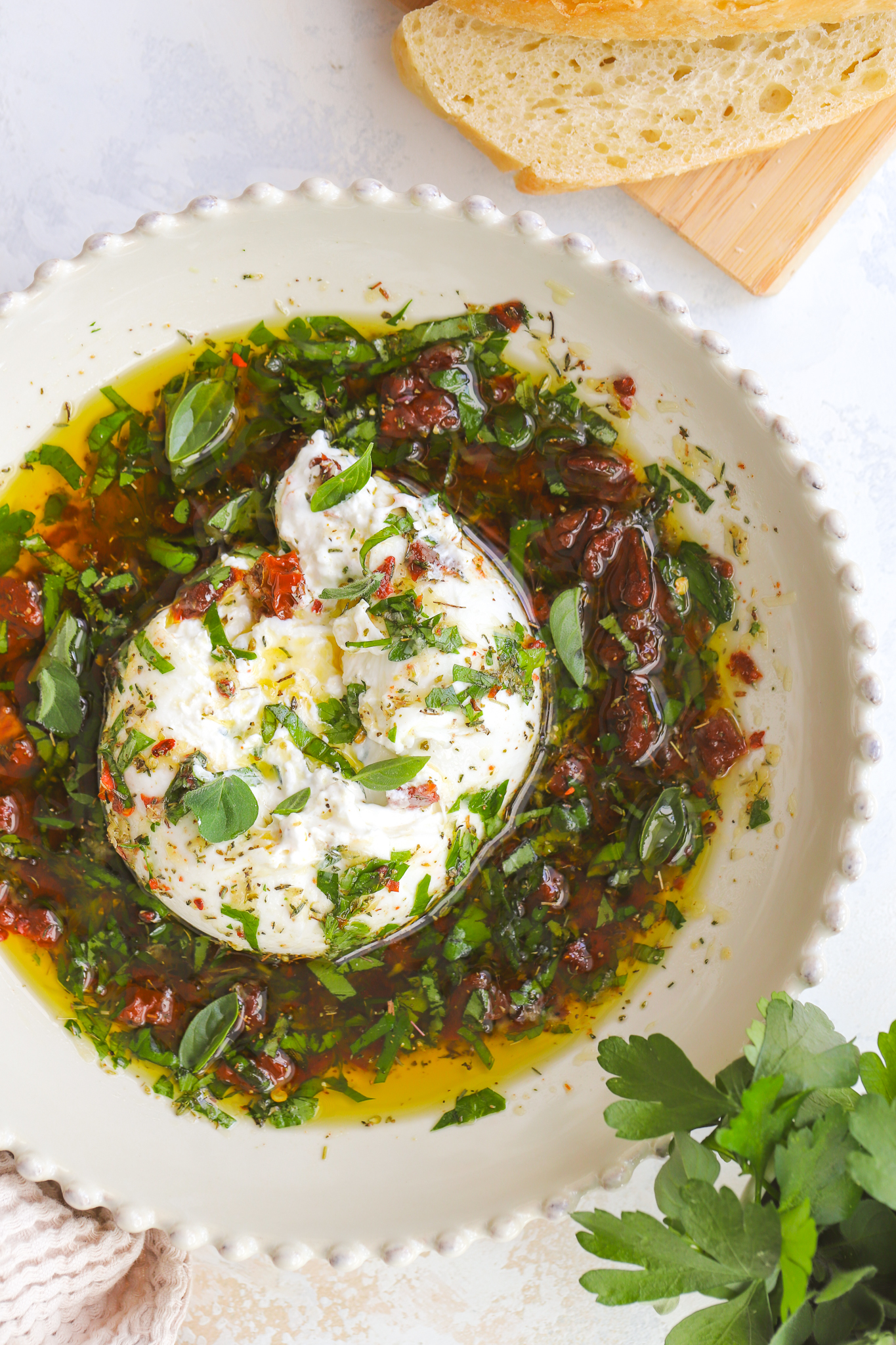 overhead of burrata in olive oil dip