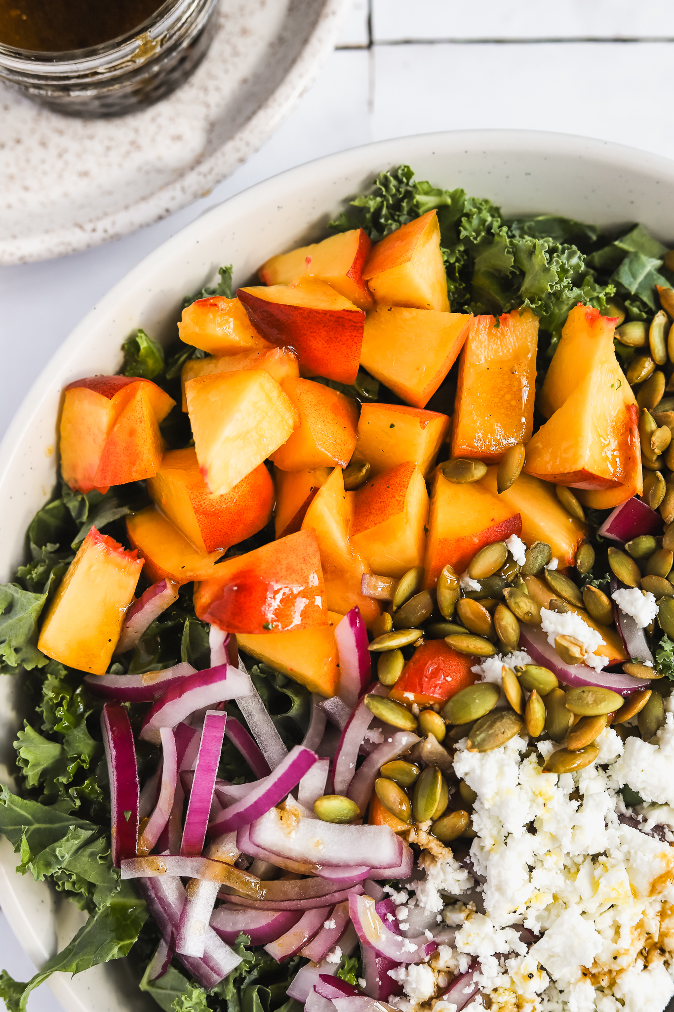 chopped peaches in a kale salad