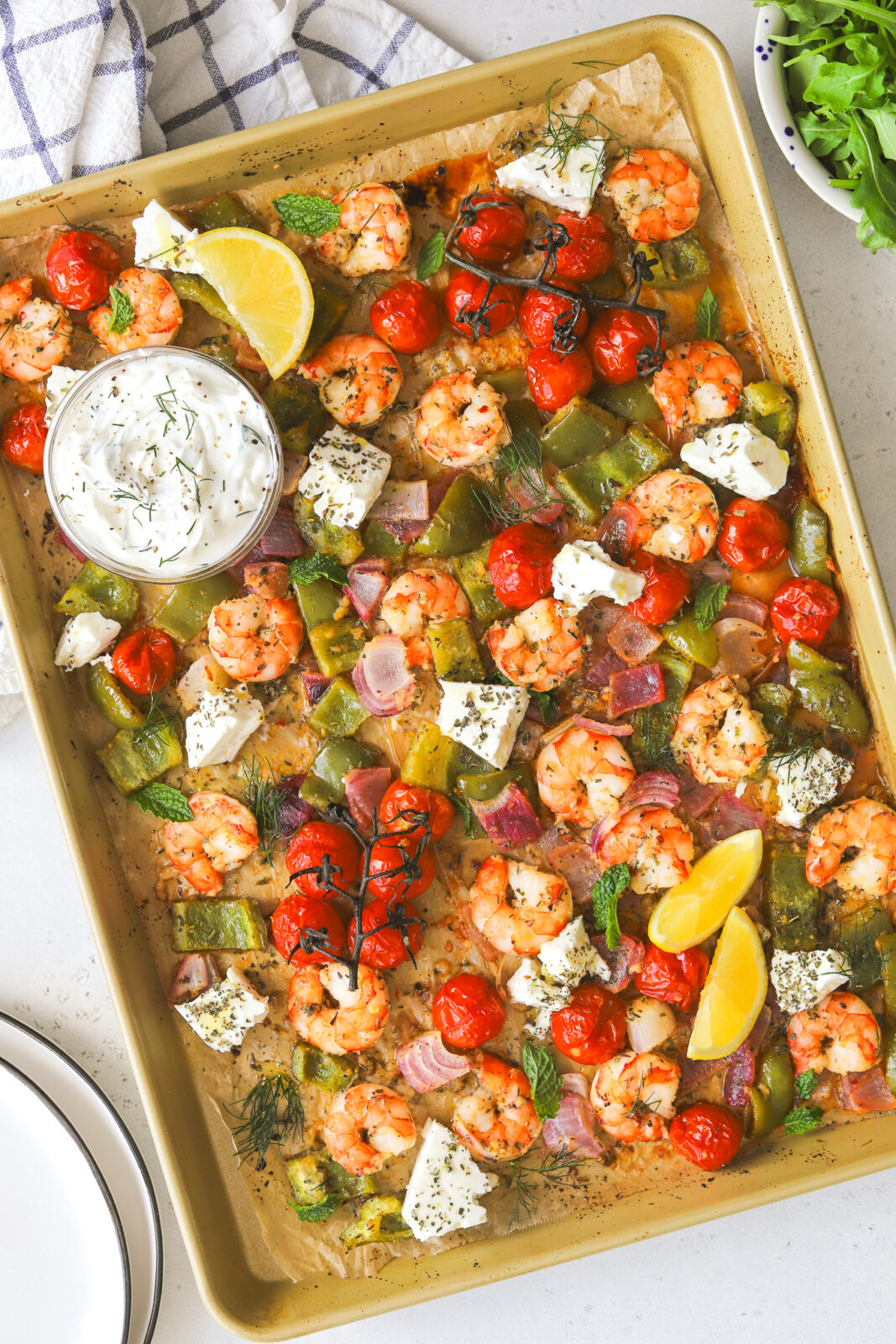 cooked shrimp and vegetables on a sheet pan