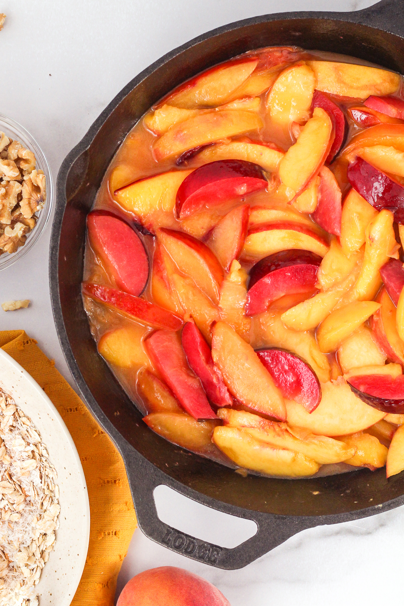peaches and plums sauteed in a cast iron pan