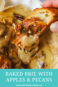 hand holding crostini dipping into baked brie