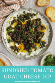 marinated goat cheese with sundried tomatoes and fresh herbs in a low bowl