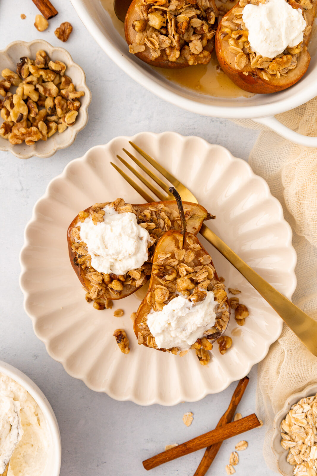 baked pears with cardamom cream on a plate