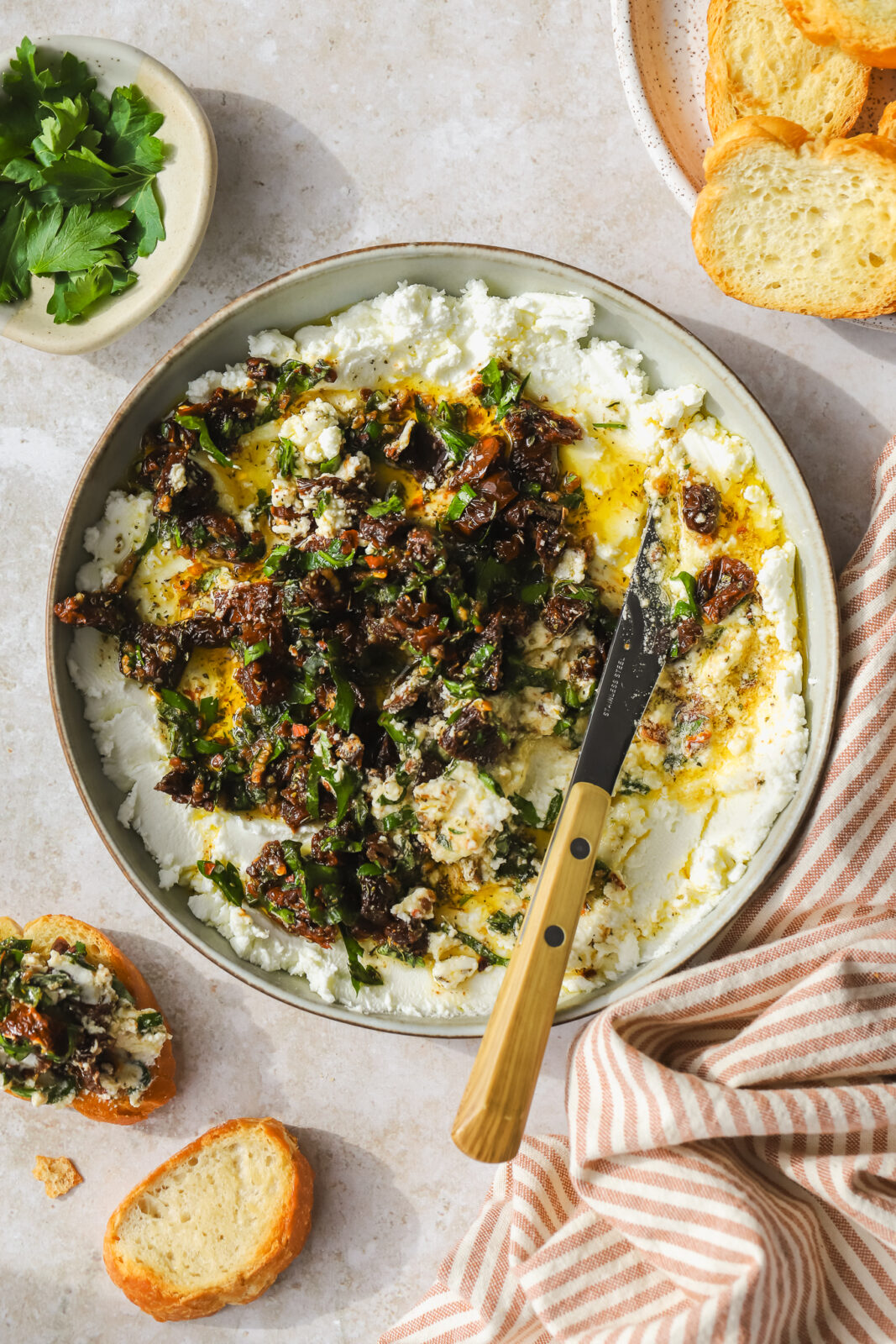 knife scooping out goat cheese dip