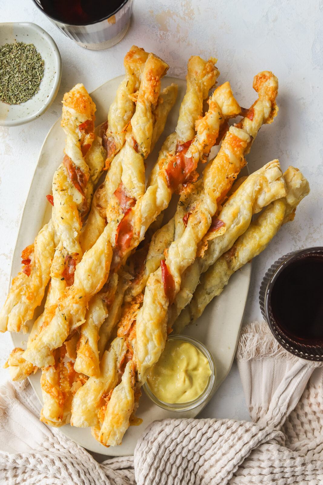 cheese twists on a serving platter with mustard