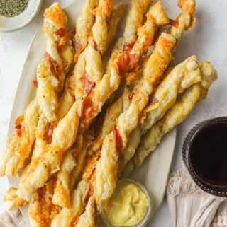 cheese twists on a serving platter with mustard