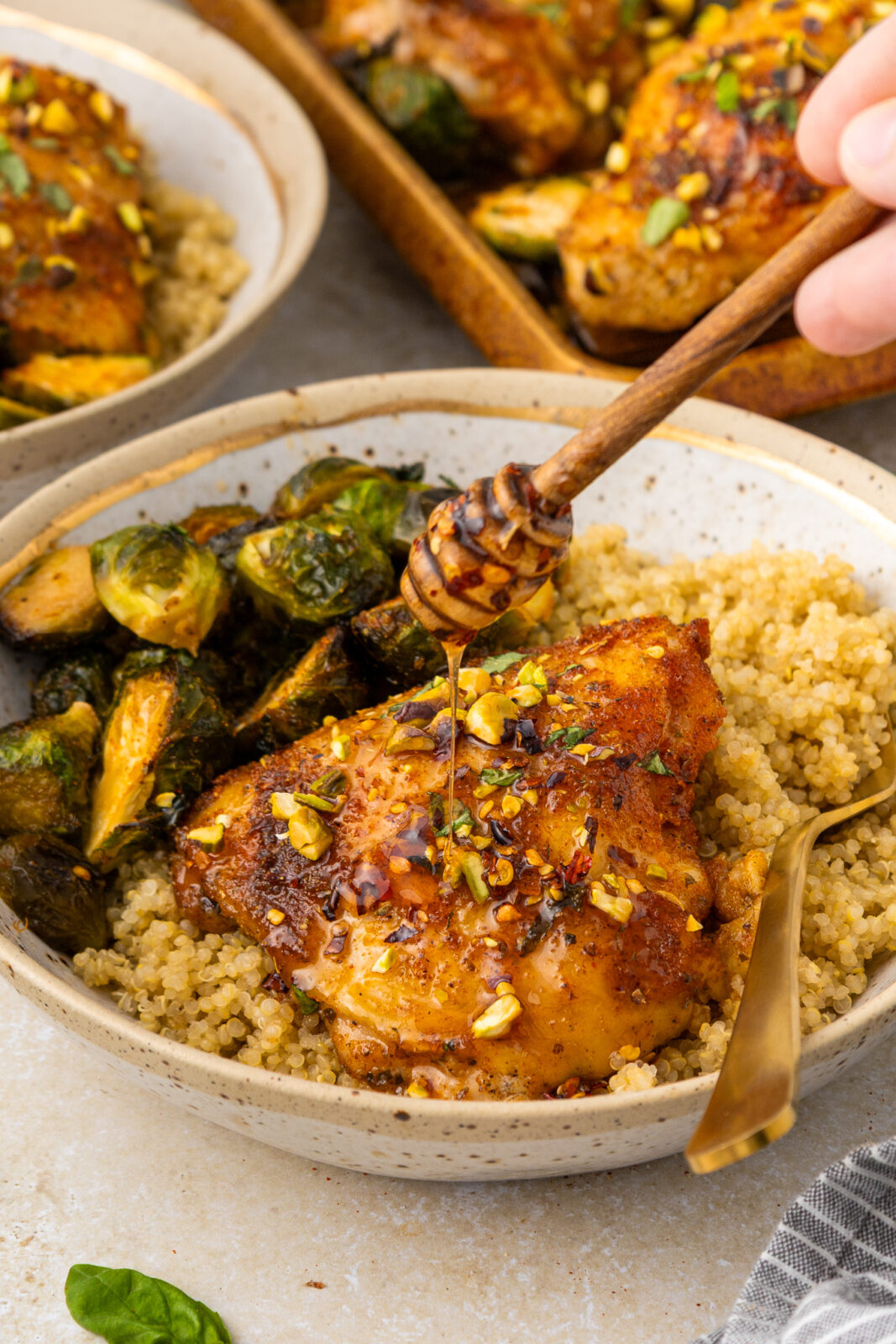 drizzling hot honey on baked chicken