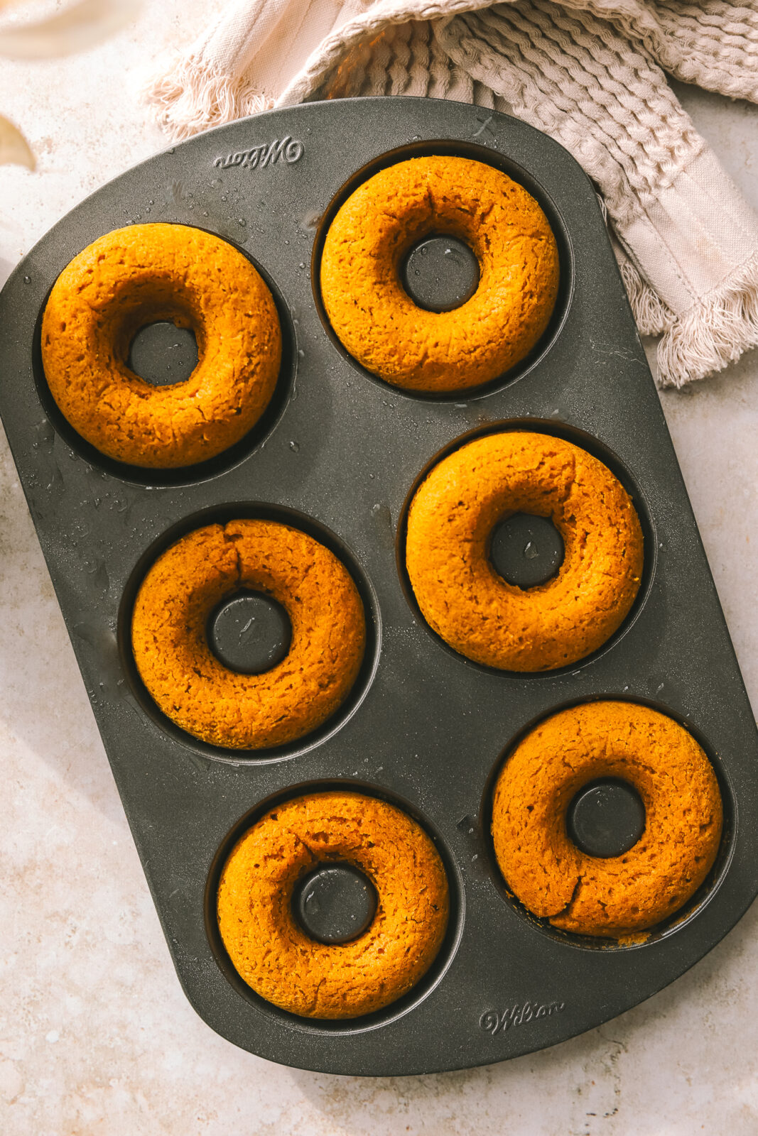 baked pumpkin donuts in a donut pan