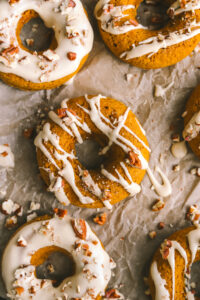 close up of pumpkin donut with maple icing