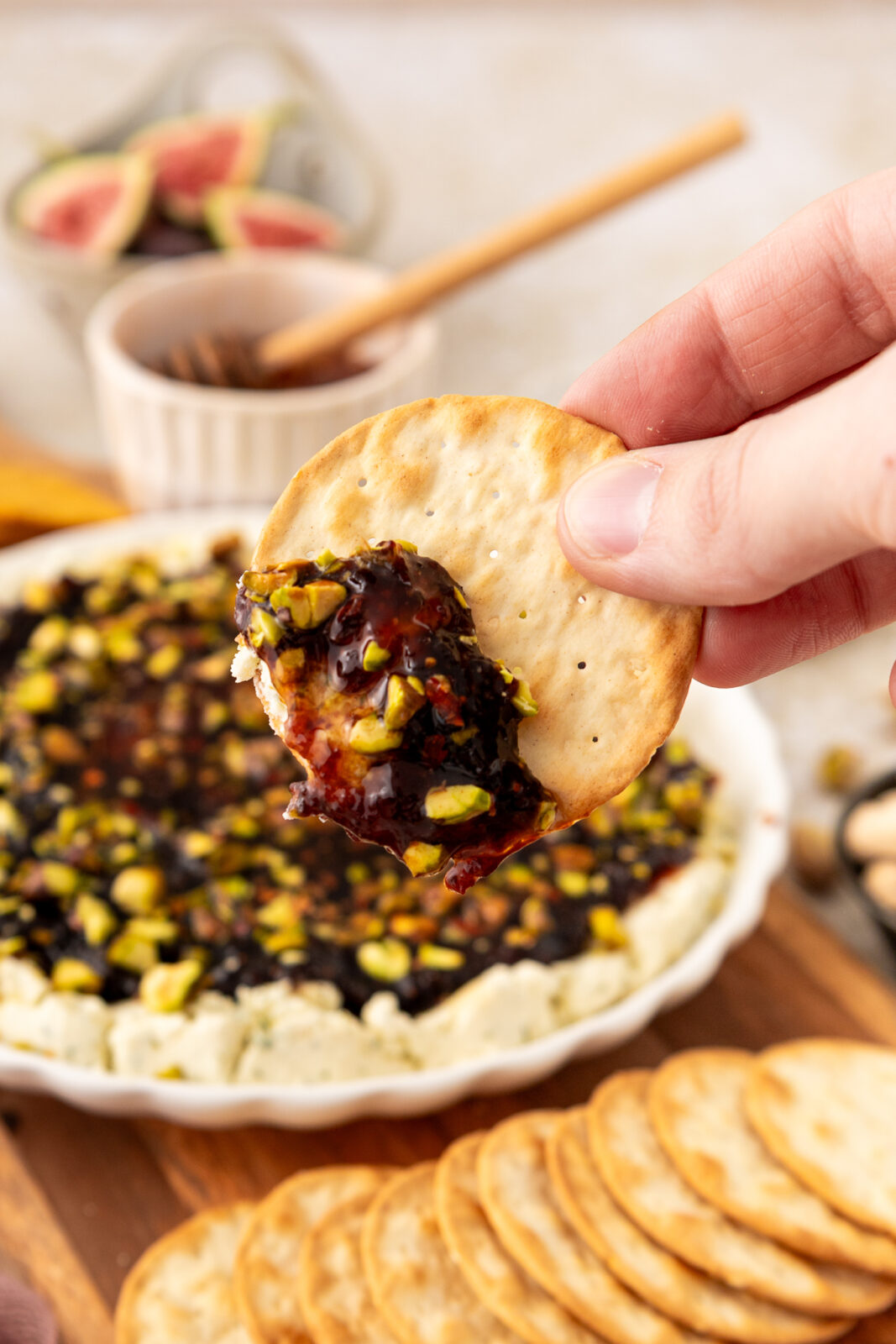 close up of cracker in boursin and fig jam dip