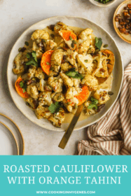 roasted cauliflower in a serving dish with orange tahini sauce