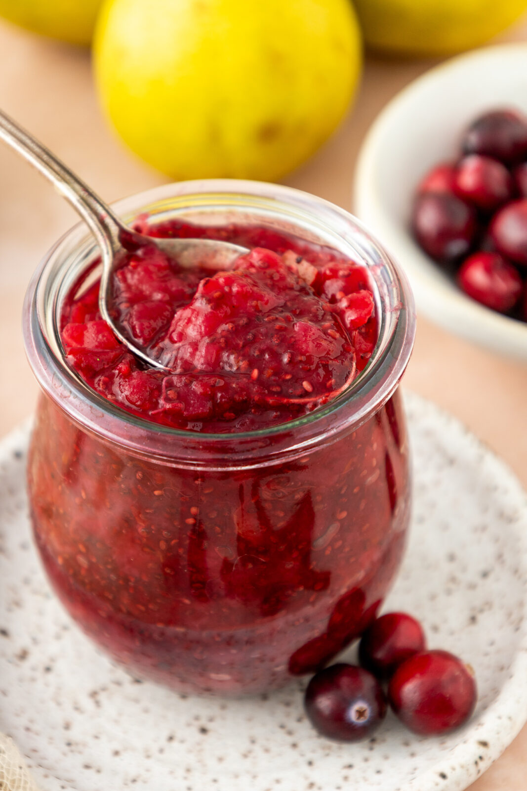 angled shot of chia cranberry pear jam on a spoon