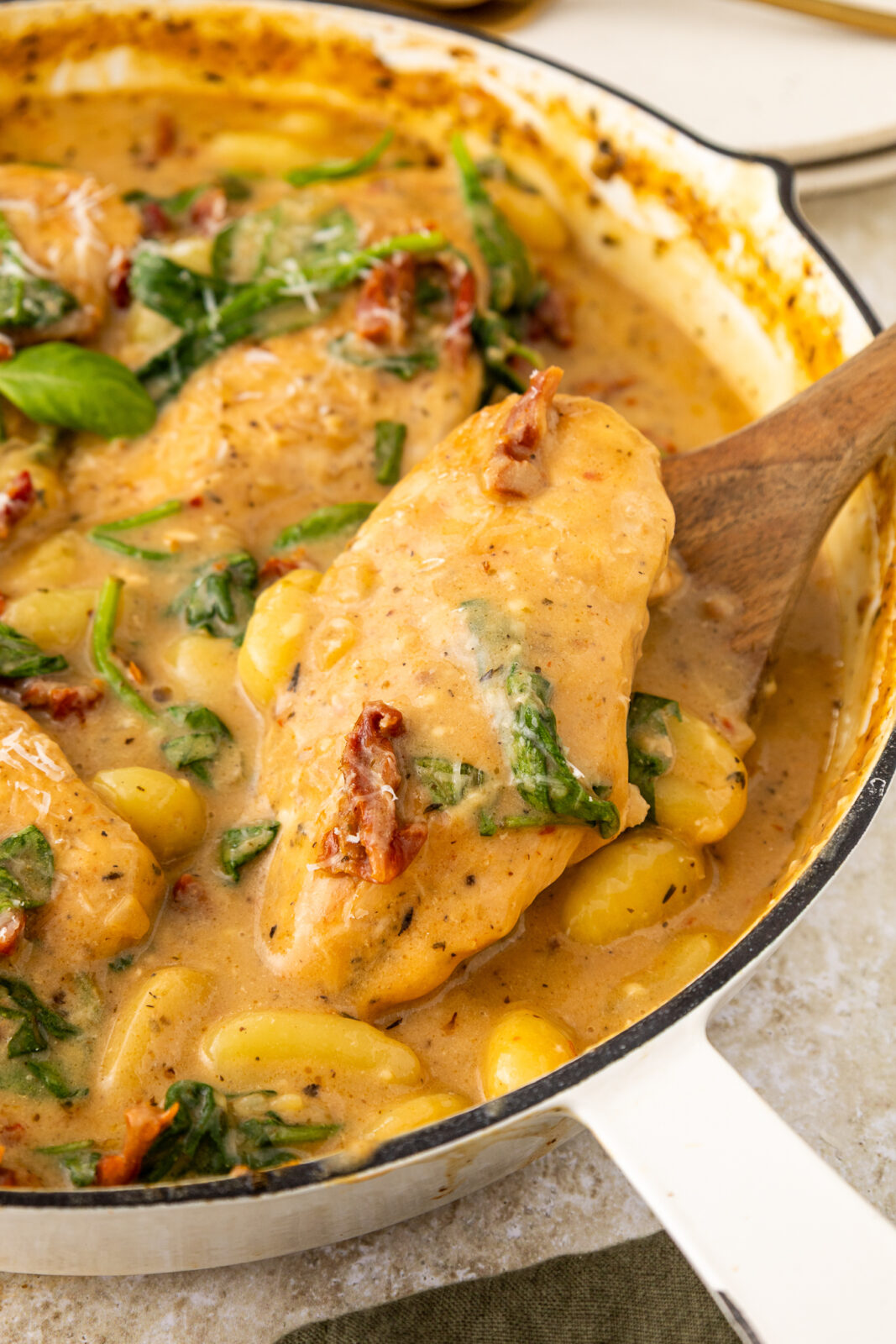 close up of a chicken breast in marry me sundried tomato sauce