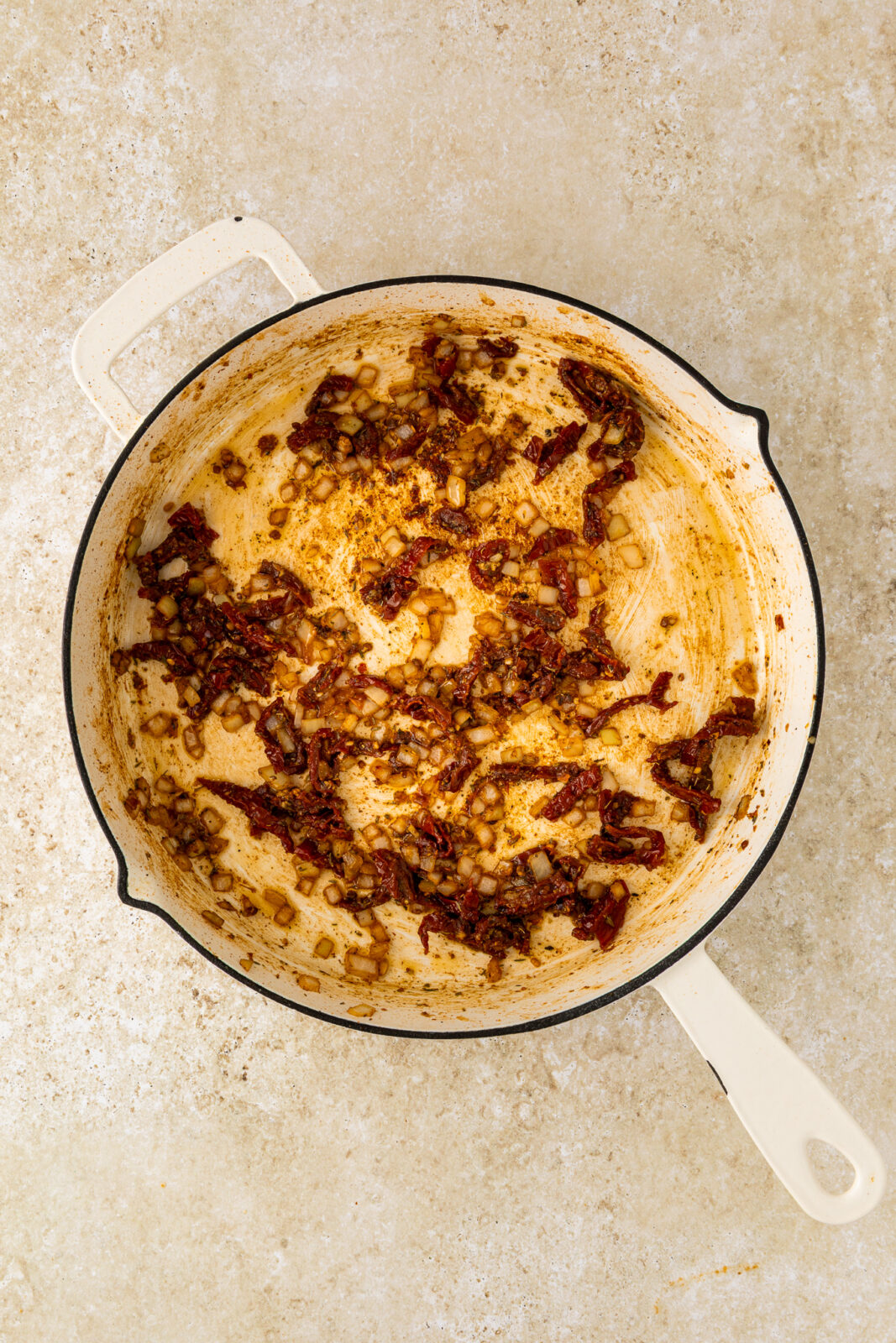 sauteed sun-dried tomatoes in a pan