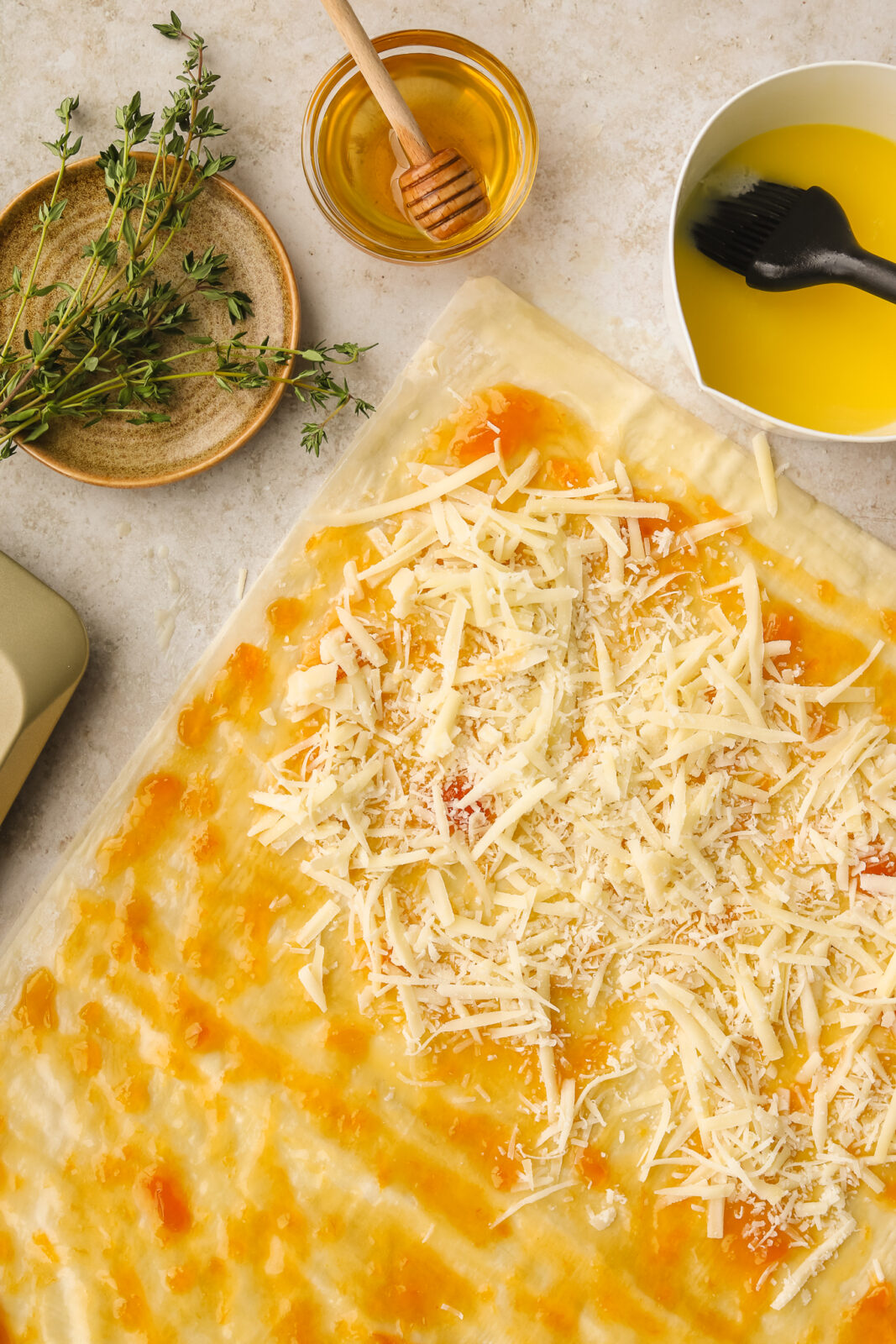 phyllo with jam and grated cheese spread on it